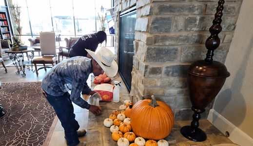 J&J Nursery crew arranging pumpkins in a lobby